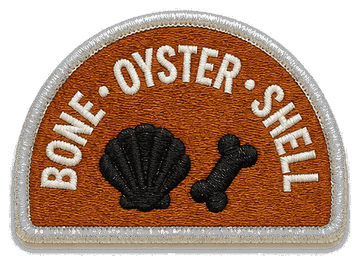 Rust embroidered patch reading BONE &middot; OYSTER &middot; SHELL, with a black scallop shell and a black bone stitched below