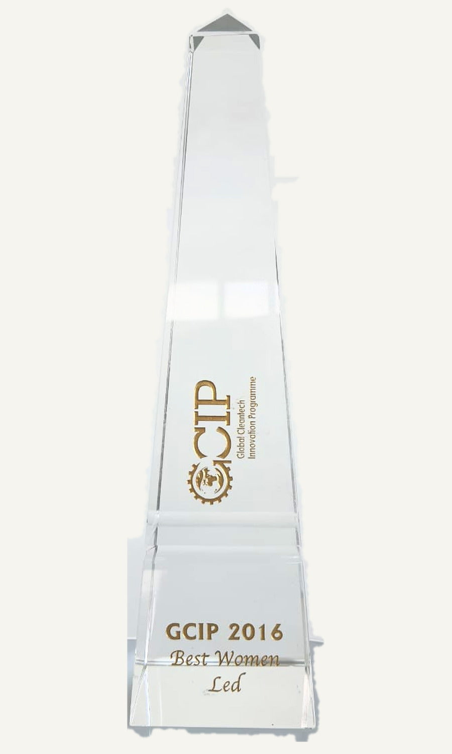 The 2016 GCIP Best Women Led award: a tall clear obelisk with a pointed cap, the GCIP mark and the citation in gold.